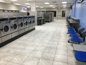 Clean, modern laundromat interior at New Hope Coin Laundry with well-maintained machines and spacious aisles