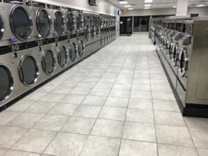 Spacious laundromat in New Hope, MN, with ample seating, folding areas, and a comfortable atmosphere.